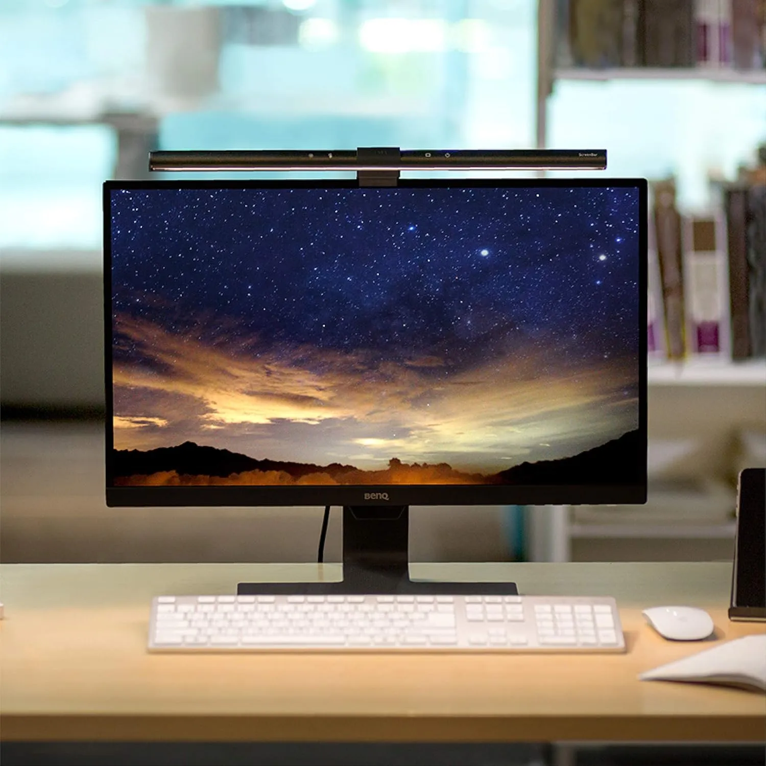 BenQ ScreenBar monitor light bar clipped onto a 27 inch display in a small home office setup