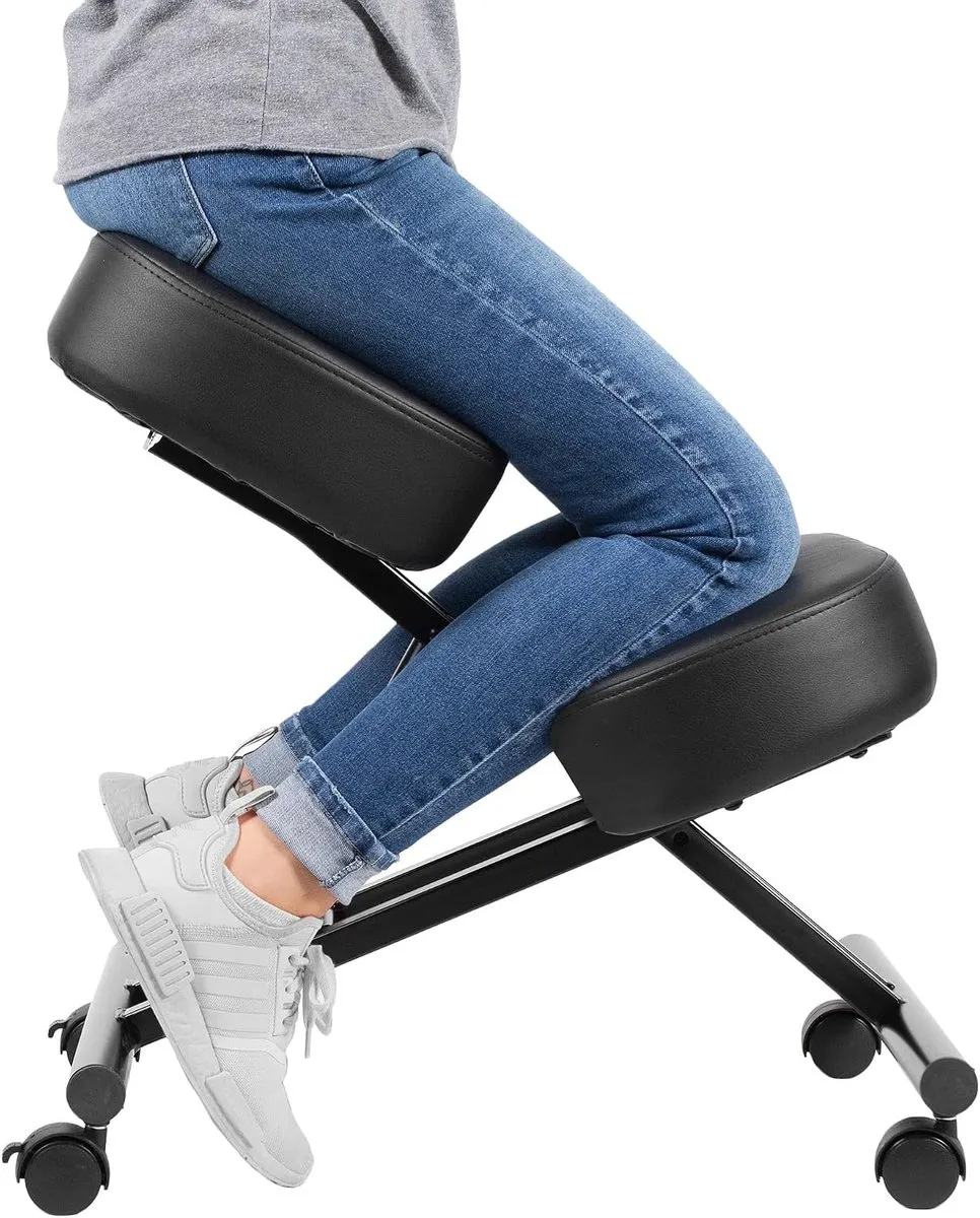 Person sitting on the black DRAGONN kneeling chair with shins resting on the lower knee pad and the X-shaped frame on four casters