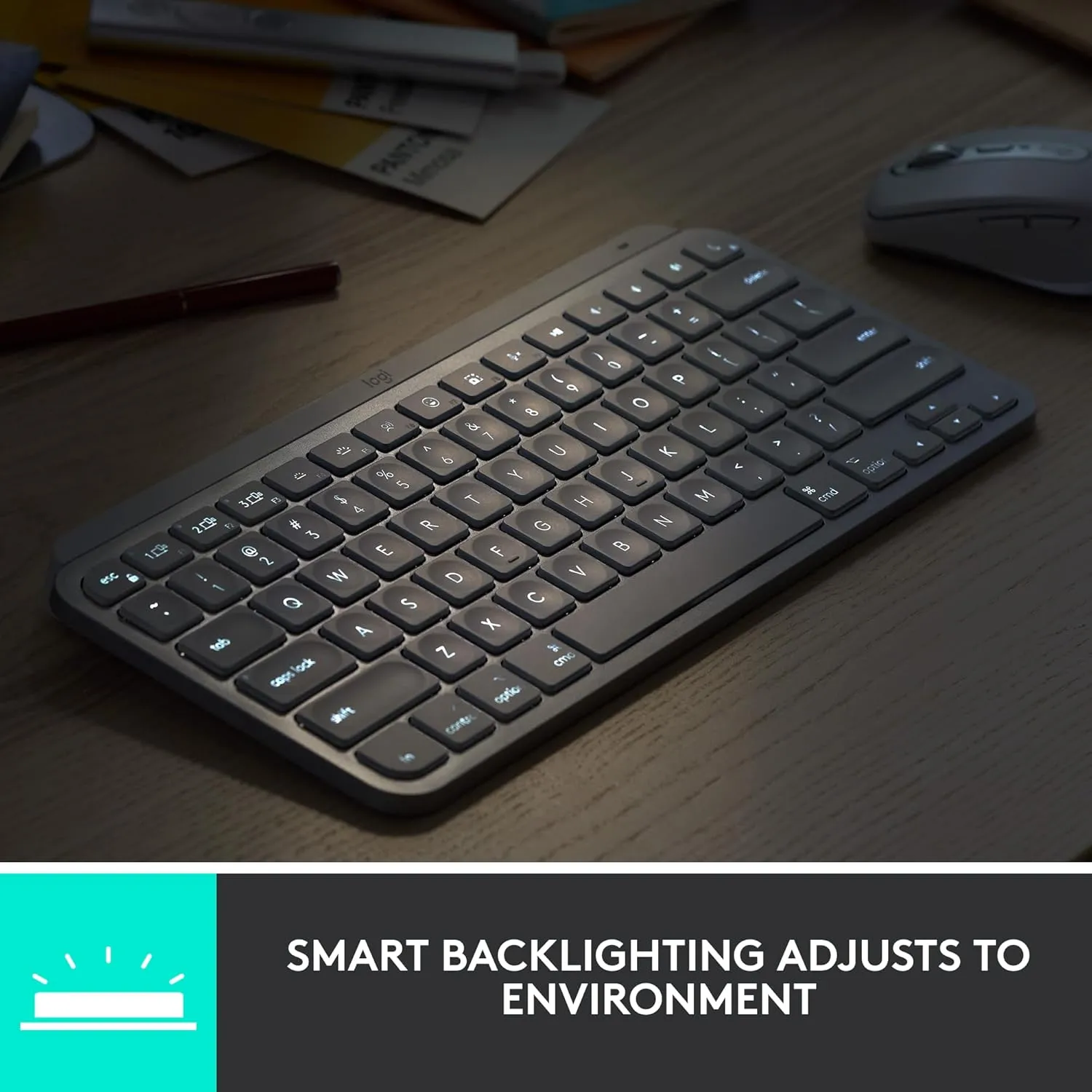 Logitech MX Keys Mini wireless keyboard in graphite on a small wooden desk next to a mouse